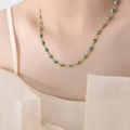 Gold chain necklace with turquoise evil eye beads on a model, stainless steel jewelry - Green Necklace
