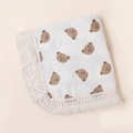 Detailed shot of soft cotton baby blanket with brown bear prints and delicate lace edges - Bear