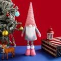 Pink and grey telescopic Christmas gnome doll with striped legs on festive background - Spiral Hair Telescopic Gnome / Pink