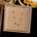 Vintage gold shell pendant necklace with green beads on a grey velvet display - XLH6146 Shell Pendant Emerald Bead Necklace Gold