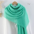 Mint green crinkled cotton linen scarf with frayed edges displayed on a wooden hanger - Mint Green