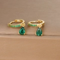 Close-up of golden teardrop earrings with pave green zircons and emerald-cut stones - Gold Green Zirconia