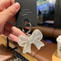 Sparkly acrylic bow keychain charm with silver metal ring, aesthetic accessory for bags - Glitter White Bow