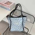 Light blue tote bag with black bow patterns and slender double shoulder straps - Blue