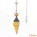 Macro shot of citrine crystal pendulum with silver hollow cap and metal chain on white background - Citrine