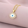 Close-up of 18K gold plated evil eye pendant with micro-inset zircons on silk background - Style G