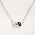 Golden necklace featuring emerald-cut clear stone and marquise-cut green gemstone charms - Gold - October