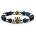 Golden crown bracelet with blue tiger eye stones and micro-pave crystals on white background - Peacock Blue Tiger Eye Gold