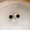 Detail view of black and white geometric pearl earrings on a white ceramic plate - 925 Silver Pin - Black and White Pearl Stud Earrings