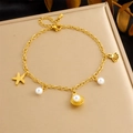 Gold stainless steel anklet with starfish charms and white pearls on a soft display stand - Starfish Pearl & Shell Style (B1588)