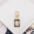 Tarot Death card keychain in gold alloy with black enamel and white skull charm - Grim Reaper
