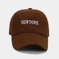 Close-up of white NEWYORK embroidery on brown cotton baseball cap with twill texture - Coffee