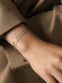 Close-up of double layered silver blade and snake chain bracelet on model wrist - Silver