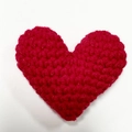 Handmade red crochet heart charm made of soft yarn for gift bouquets and holiday decor - Red Heart