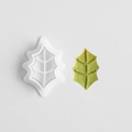 Leaf-shaped white plastic cookie cutter with a green embossed Christmas cookie - E0853-Holly Leaf