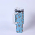 Close-up of 40oz stainless steel tumbler with orange floral pattern and white handle - Orange White Floral/Blue