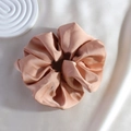 Close-up of a premium pink satin scrunchie with a soft silk texture and elegant shine - Rose Pink