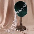 Elegant bridal hair band with white pearls and woven wire on a green velvet head model - White