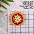 Top view of a 5.3cm miniature resin pizza fridge magnet on a grid measuring scale - Style G