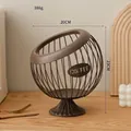 Dark brown metal coffee capsule basket with sphere hollow design and stable base - Elevated Style: Noble Coffee Basket
