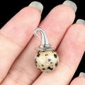 Wizard hat pendant featuring spotted stone and silver metal finish on finger - Dalmatian Jasper