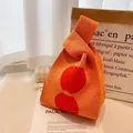 Vibrant orange knitted wrist bag with red cherry pattern for daily commute fashion - Orange Red Apple