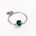 Detail of silver chain ring featuring an oval green zircon and heart charm pendant - Green Zirconia - Silver Plated