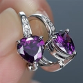 Macro shot of heart-shaped purple zircon earrings with small micro-pave diamonds detail - Platinum Plated Purple Zirconia