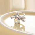 Bow ear cuff with multi-faceted colorful stone on a beige tray, high-quality jewelry - Left Ear / Iridescent (Moonlight)