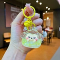 Detail of yellow shiba inu keychain with oil-filled liquid glitter and bell charm - Lobster Clasp Style / Noctilucent Bubble Bead Yellow Style