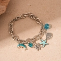 Silver marine charm bracelet featuring blue starfish, turtle, and dolphin pendants - Blue Dolphin Shell Star Pendant Bracelet