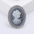 Vintage oval relief brooch with grey woman silhouette and sparkling diamond frame - Silver