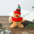 Knitted gingerbread man doll with red scarf and Christmas hat on a wooden floor - Flat Gingerbread Man Pendant Sharp Hat