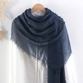 Deep blue crinkled cotton linen hijab scarf with elegant fringe trim hanging on wall - Dark Blue