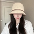 Beige crochet straw bucket hat with brown trim and bow detail worn by a model - L (54cm-58cm) / Beige Striped