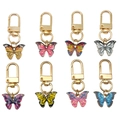 Set of eight colorful butterfly metal keychains with golden hooks on white background - Butterfly Collection (ER647)