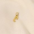 Close-up of golden letter F pendant with polished finish on beige fabric background - Letter-J