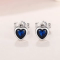 Macro detail of heart-shaped earrings with deep blue gemstones and silver metal finish - Dark Blue