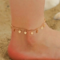 Golden double-layer anklet with wave tubes and hanging heart sequins on a sandy beach - KC Gold Wave Heart Style (3879)