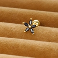 Macro shot of 925 silver flower stud earrings with marquise black stones and ball back - Gold/Black Zirconia