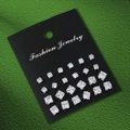 Close-up of twelve pairs of square zircon stud earrings on a black fashion jewelry card - Square Rhinestone Style (S3637-3)