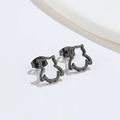 Macro shot of minimalist black stainless steel owl stud earrings with a matte finish - Owl / Black