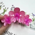 Pink translucent resin flower hair claw clip featuring three five-petal floral blossoms - Pink