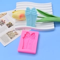 Detail view of silicone mold showing bow and polka dot textures on a gift box design - Bow Long Gift Box Style (2) / Pink