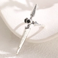 Close-up of gothic silver cross sword ring with black center stone on a white display - Long Sword (3037) / Antique Silver