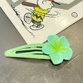 Detailed close-up of a green flower hair clip with semi-transparent petals and yellow center - Green