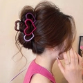 Gradient purple and pink large heart hair claw clip styled in a classic bun - Hollow Triple Pink Purple Hearts