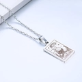 Macro shot of silver stainless steel Capricorn pendant with engraved zodiac pattern - Capricorn / Steel