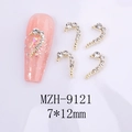 Macro detail of J-shaped gold nail art charms with white rhinestones, size 7x12mm - Gold Base White Rhinestone Right Style (MZH-9121)