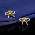 Elegant bow-shaped silver stud earrings featuring yellow oval-cut gemstone and white zircons - Yellow Diamond Bow Earrings Led-137